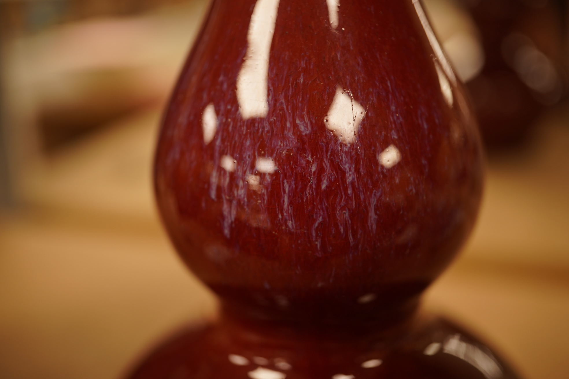 A Chinese Sang De Boeuf glazed double gourd vase, 14.5cm high